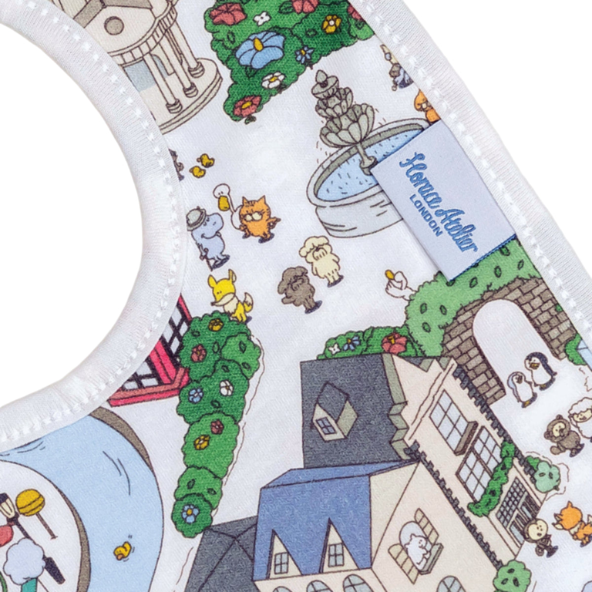 Children's plate with cartoon designs of houses, trees, and animals on a white background.